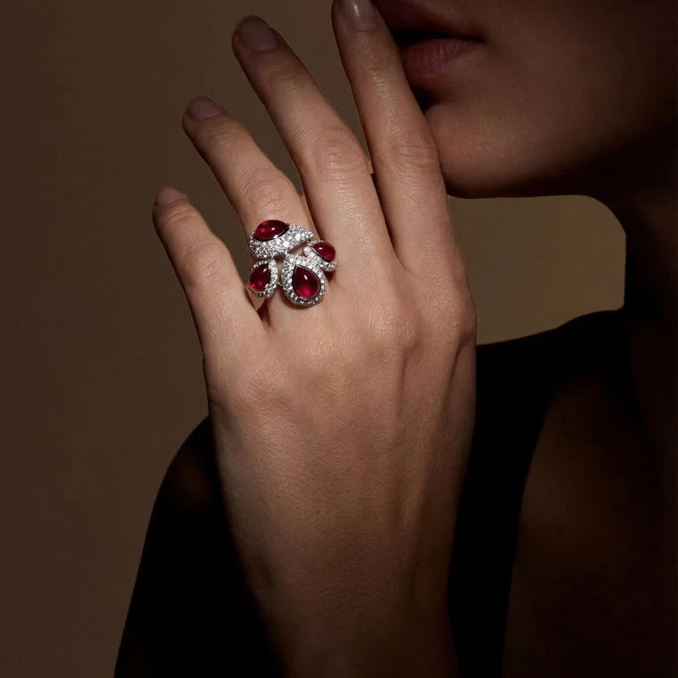 Close-up of a ruby and diamond ring worn on a model’s hand